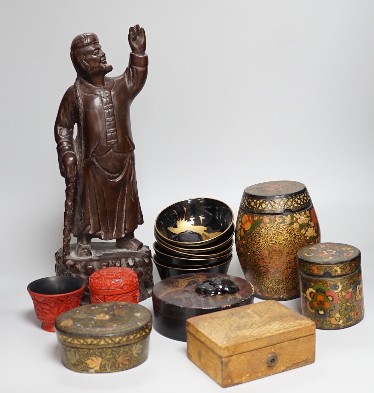 A Japanese red lacquer natsume, 7cm high, and matching tea cup Together with Mixed decorative Oriental and Indian lacquer wares and, a Chinese carved hardwood figure of a sage 39.5cm
